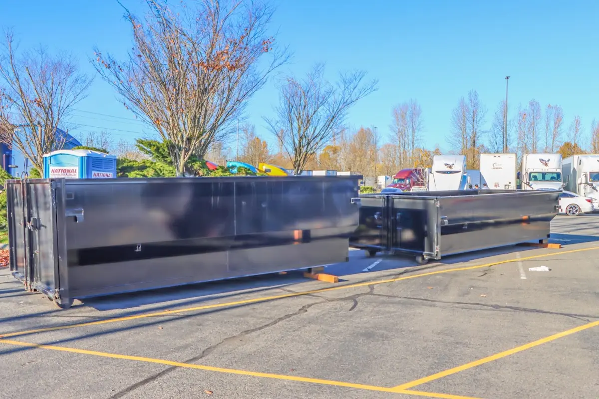 Professional dumpster rental service with roll-off container on residential driveway in West Manchester